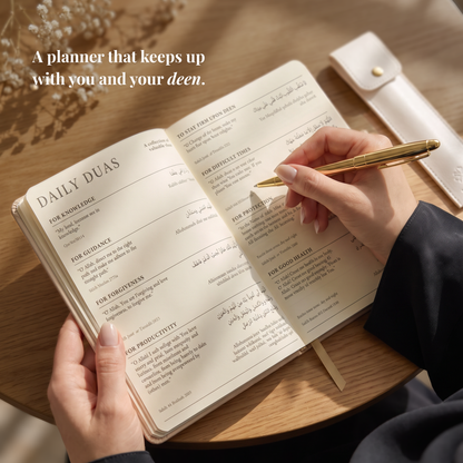 The Deen Planner open on a desk with a gold pen, coffee and laptop in the background