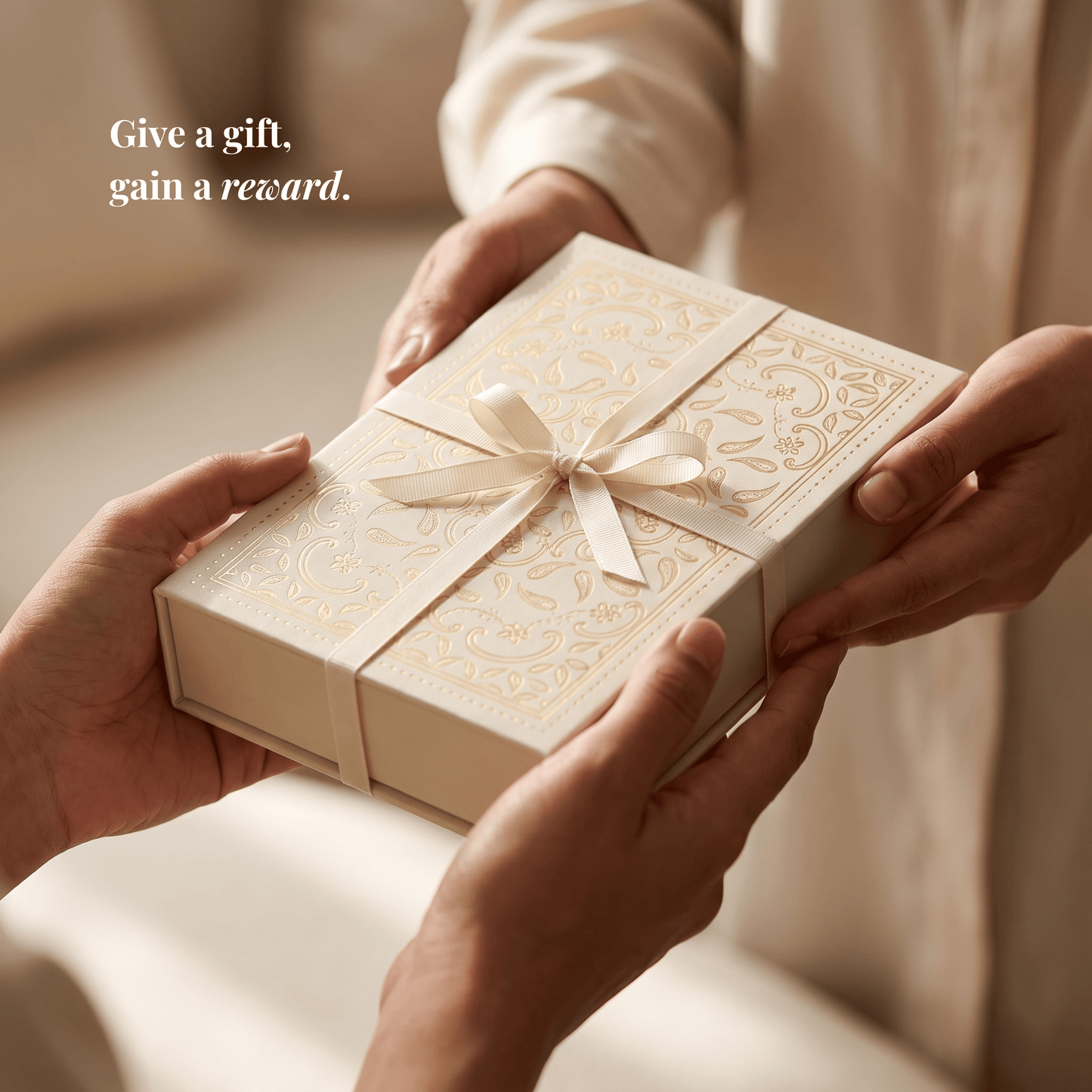 Hands exchanging the mmalikart luxury gift box tied with a cream ribbon, the perfect gift for uni or school