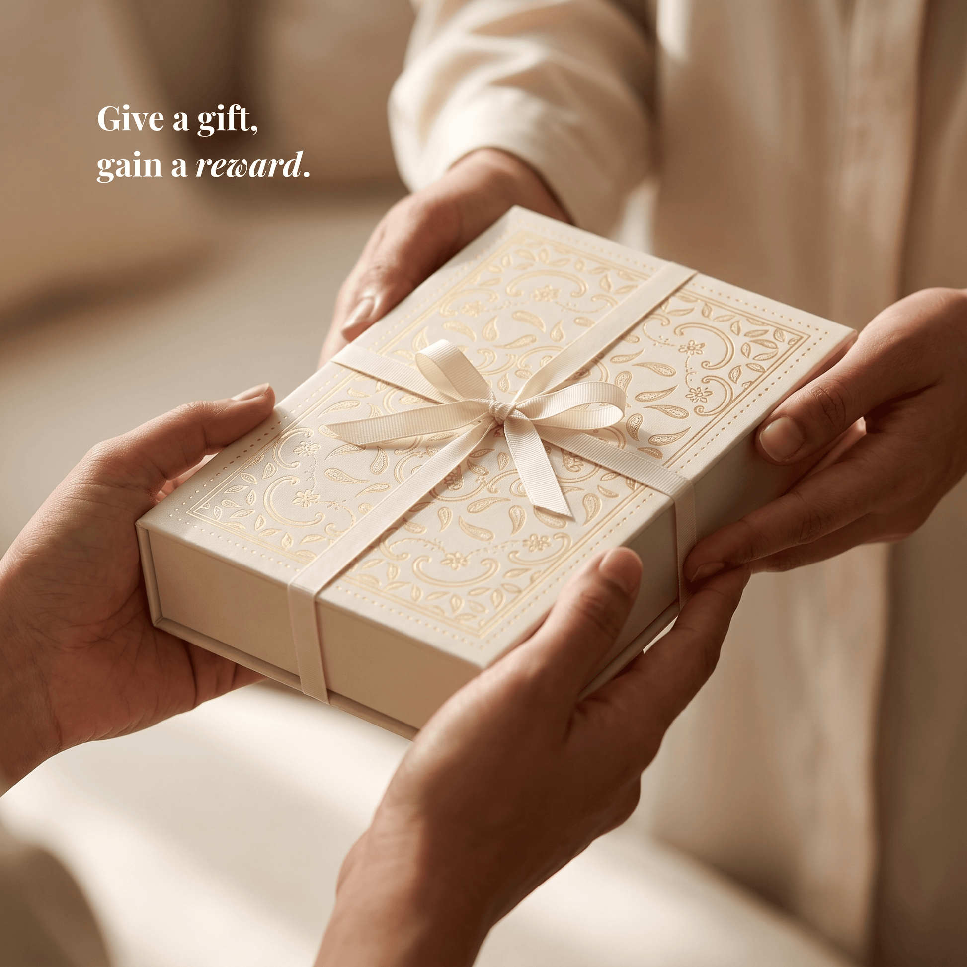 Hands exchanging the mmalikart luxury gift box tied with a cream ribbon, the perfect gift for uni or school
